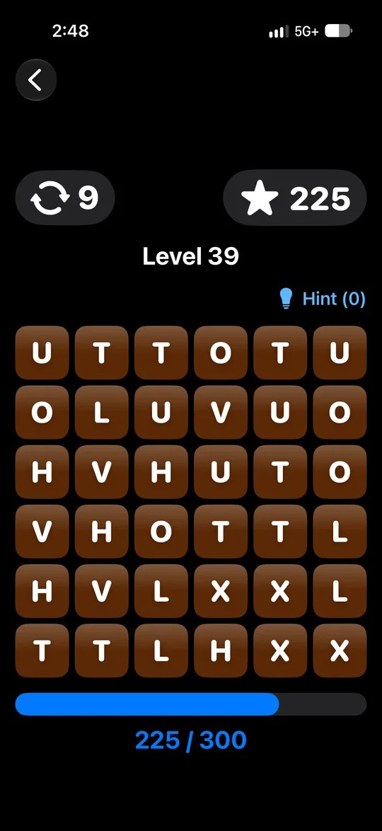 A GlyphMatch level in progress: a grid of brown letter tiles with moves and score at the top.